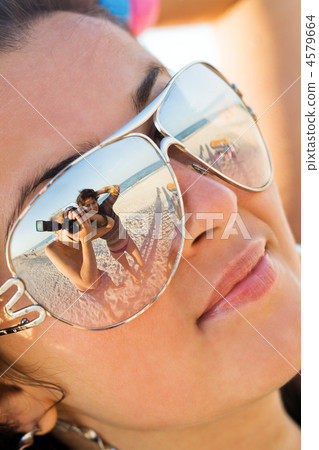Reflexion of the photographer in model glasses 4579664