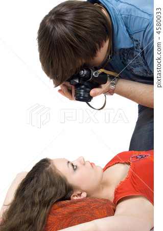 Photographer taking pictures of the young woman 4580033