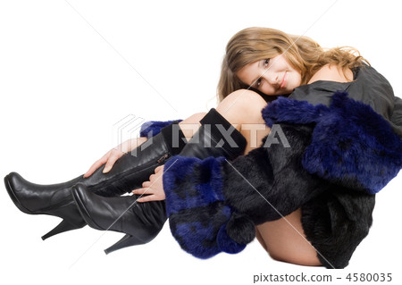 Beautiful smiling girl in a fur coat and boots Beautiful smiling girl in a fur coat and boots 4580035