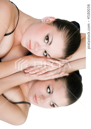 Beautiful young woman and her reflection in mirror Beautiful young woman and her reflection in mirror 4580036