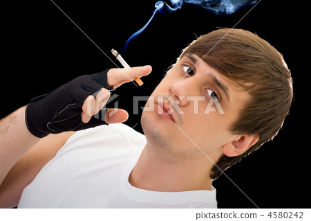Young man with a cigarette. Isolated on black Young man with a cigarette. Isolated on black 4580242