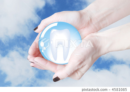 hands holding tooth in glass sphere, dentistry 4581085