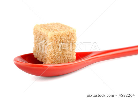 Cane sugar cube in spoon isolated on white background Cane sugar cube in spoon isolated on white background 4582204