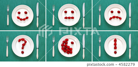 Food concepts - faces and symbols made of strawberries on plate 4582279