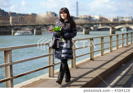 Happy beautiful girl with tulips enjoying spring day in Paris Happy beautiful girl with tulips enjoying spring day in Paris 4584128