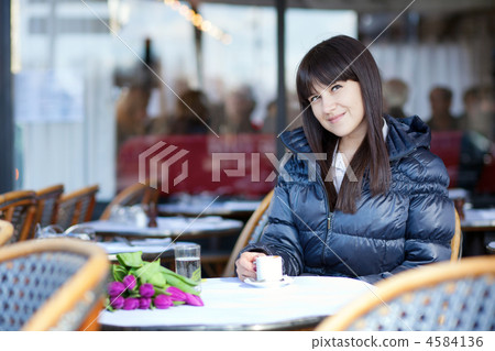 Smiling brunette lady in Parisian street cafe 4584136