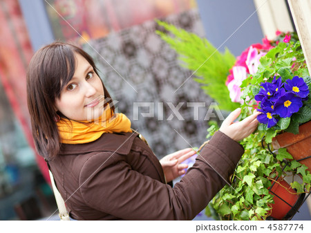 Beautiful young woman with flowers outdoors 4587774