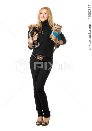 Smiling pretty young blonde posing with two dogs Smiling pretty young blonde posing with two dogs 4600255