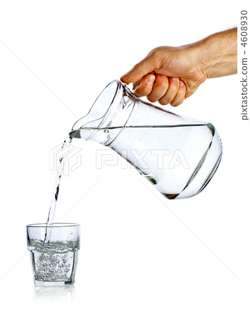 Hand pouring water from glass jug Hand pouring water from glass jug 4608930