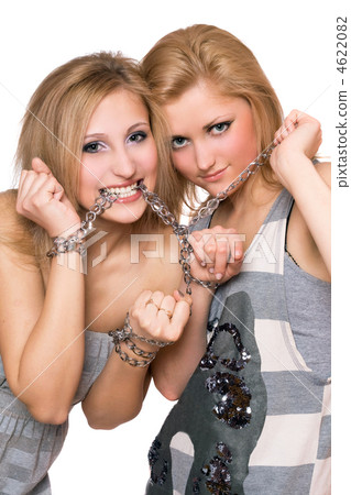 Two playful young women bound a chain 4622082