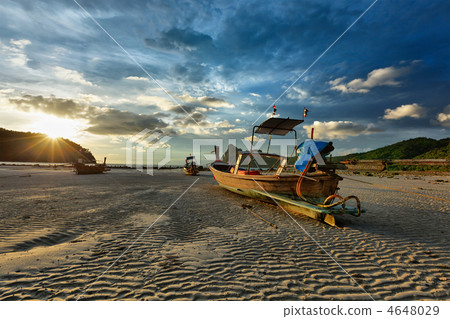 Long tail boat on beach on sunset 4648029