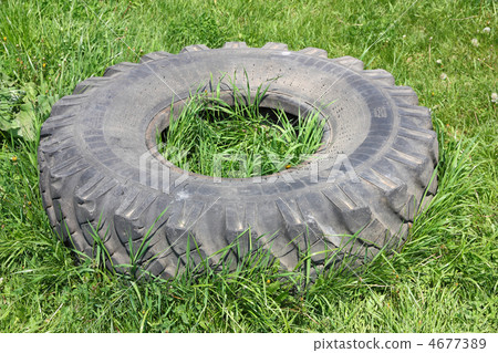 old automobile wheels on a green grass 4677389
