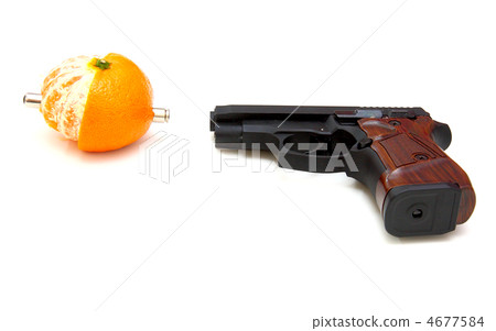 The close up of a pistol a tangerine The close up of a pistol a tangerine 4677584
