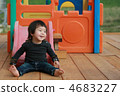 A child with a smile sliding on the slide 4683227