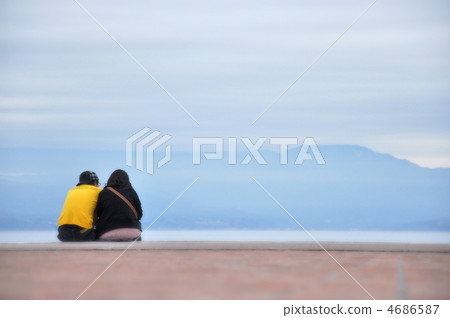 A couple snuggly at the beach A couple snuggly at the beach 4686587