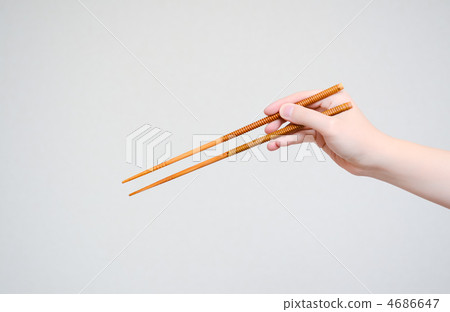 Hands holding chopsticks 4686647