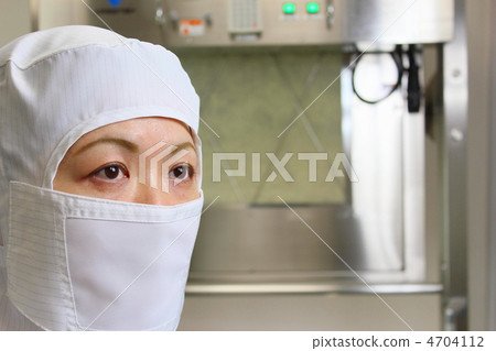 一個女人在潔淨室設施前無塵衣服 一個女人在潔淨室設施前無塵衣服 4704112