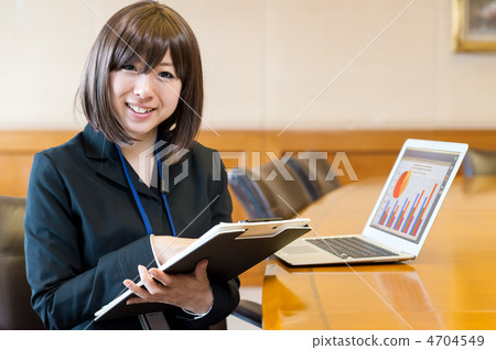 Business woman sitting in front of a laptop Business woman sitting in front of a laptop 4704549