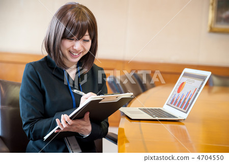 Business woman sitting in front of a laptop Business woman sitting in front of a laptop 4704550