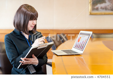 Business woman sitting in front of a laptop Business woman sitting in front of a laptop 4704551