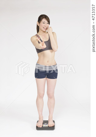 A woman happy to ride on a scale 4713357