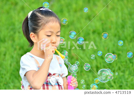 Girls playing with soap bubbles Girls playing with soap bubbles 4713519