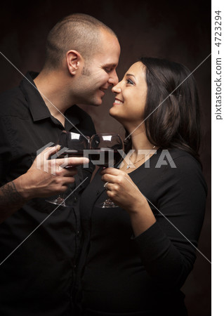 Happy Mixed Race Couple Flirting and Holding Wine Glasses Happy Mixed Race Couple Flirting and Holding Wine Glasses 4723294