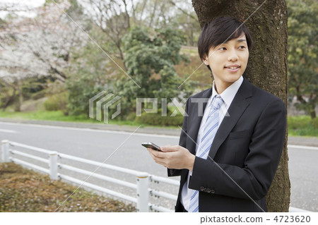 A businessman operating a smartphone 4723620