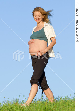 pregnant woman on meadow 4728433