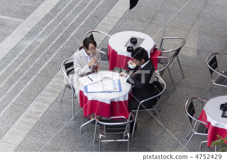 Business man and business woman taking a break at the cafe Business man and business woman taking a break at the cafe 4752429