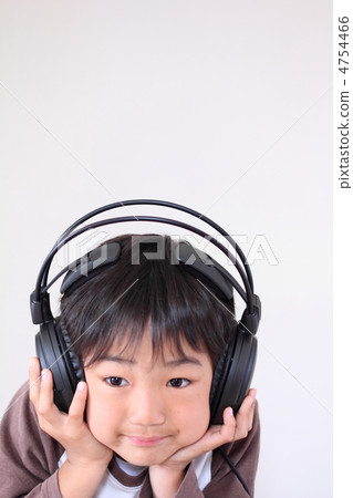 Boy listening to music with headphones Boy listening to music with headphones 4754466