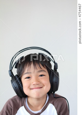 A smiley boy with headphones on listening to music A smiley boy with headphones on listening to music 4754467