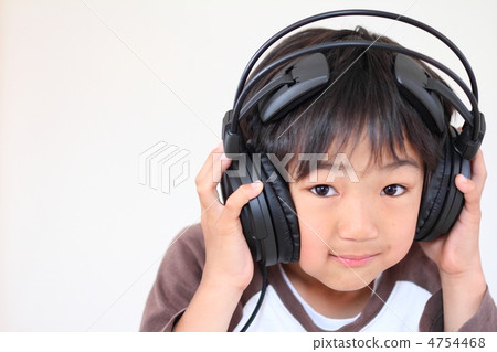 Boy listening to music with headphones Boy listening to music with headphones 4754468