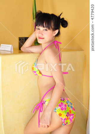 A young woman in a bikini taking a pose A young woman in a bikini taking a pose 4779420