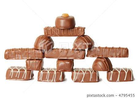 many chocolate appetizing candys with icing pyramid figure, full many chocolate appetizing candys with icing pyramid figure, full 4795455