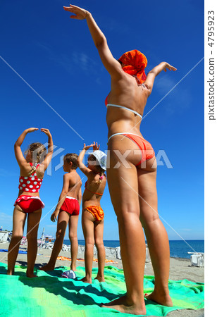 Mother and her children, son and two daughters, standing back on 4795923