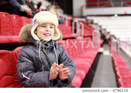 Boy with delight claps one's hands on hockey match Boy with delight claps one's hands on hockey match 4796234