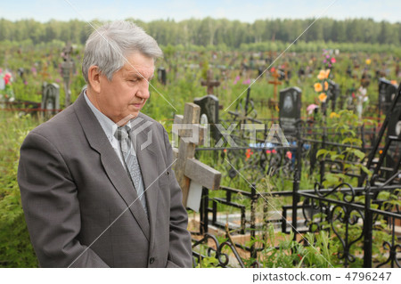 old sad senior in grey suit standing on cemetery and looking at old sad senior in grey suit standing on cemetery and looking at 4796247