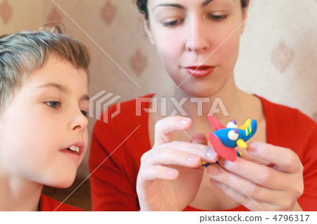 Mother and son play with home-made elephant from plasticine Mother and son play with home-made elephant from plasticine 4796317