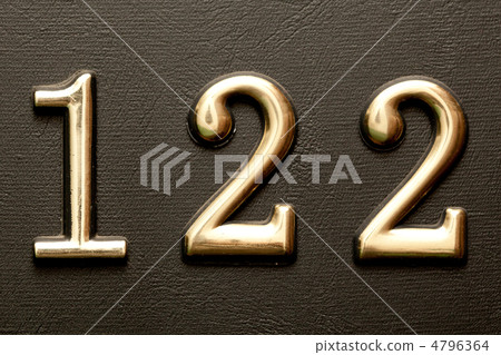 Brass door number 122 on the dark leather background. 4796364