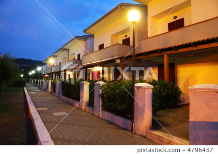 Little street with two-storeyed cottages which is lighted up rou 4796437