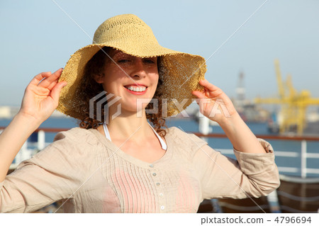 Beautiful smiling girl trying on straw on deck of cruise ship 4796694