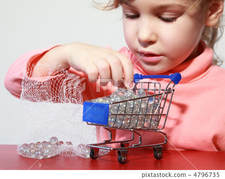 Cute little girl care play with toy shopping trolley filled by s Cute little girl care play with toy shopping trolley filled by s 4796735