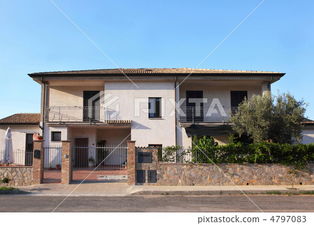 Front view on  white two-storeyed cottage with balconies and cou 4797083