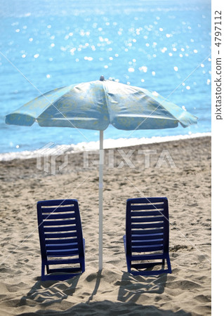 Ashore  in  day-time on sand two empty plastic chairs cost under 4797112