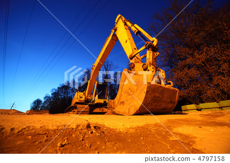 Big yellow crawler tractor with big bucket on yellow sands at ni 4797158