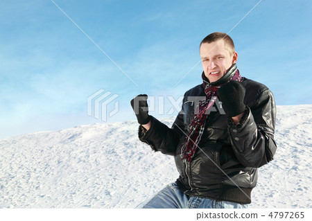 Student stands on snow in winter and clench hands in fists Student stands on snow in winter and clench hands in fists 4797265