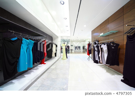 Womanish evening dresses hang in shop Womanish evening dresses hang in shop 4797305