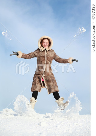 Girl jumps and throw snow hands and feet Girl jumps and throw snow hands and feet 4797359