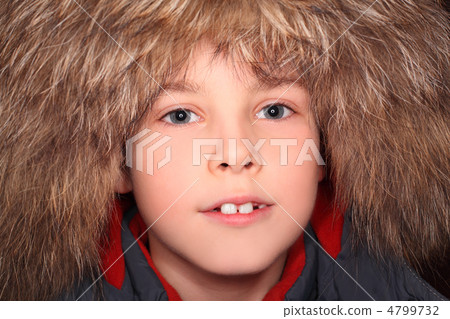 portrait of little boy in big fur hood, looking at camera 4799732